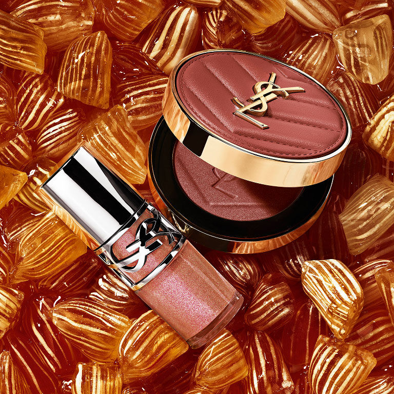 YSL LOVESHINE Plumping Lip Oil Gloss shade 12 and Make Me Blush shade 12, nestled among golden berlingot sweets.