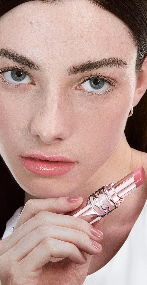 Chloe, radiant in YSL LOVESHINE Candy Glow 44b, product in hand, lips shimmering with a subtle, fresh allure.