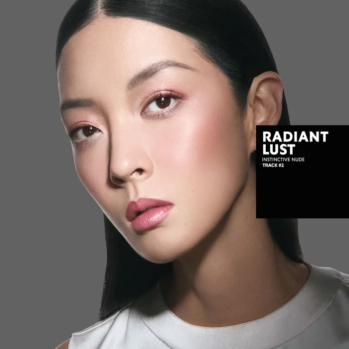 Karen, tanned skin tone, with an instinctive nude eye look and blazing desire glossy lips, wearing a white top.