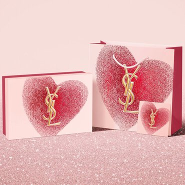 YSL Beauty Valentine's day gift set, gift card, and shopping bag, featuring a glittery red heart design with the YSL logo.