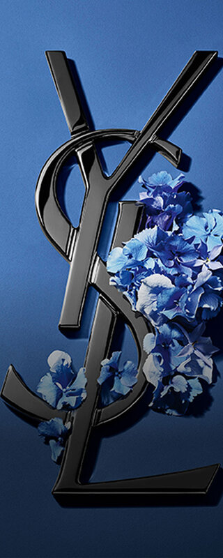Black YSL Cassandre logo adorned with vibrant blue spring flowers, set against a serene blue background.
