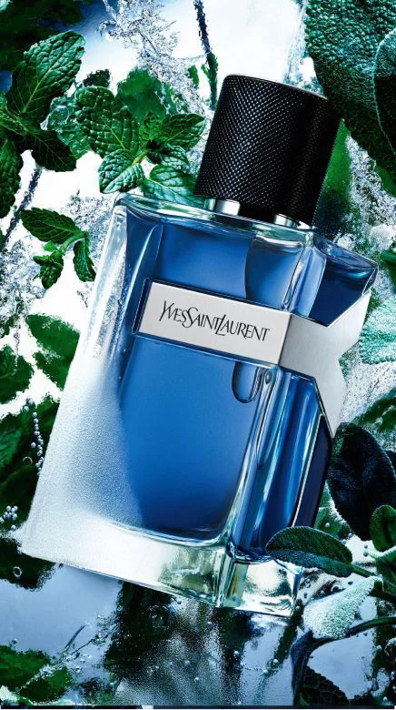 YSL Y Eau de Toilette Intense Iced Cologne bottle, with frosted glass, surrounded by vibrant mint leaves and icy water.