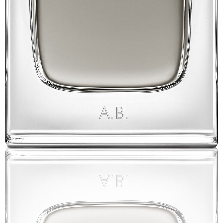 Close-up of the MYSLF Eau de Toilette Intense bottle base featuring personalized A.B. initials engraving.