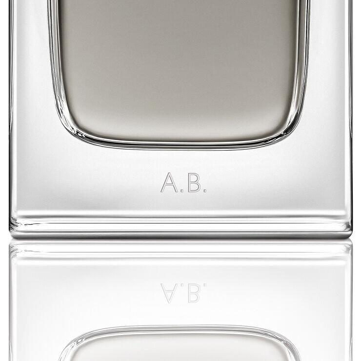 Close-up of the MYSLF Eau de Toilette Intense bottle base featuring personalized A.B. initials engraving.