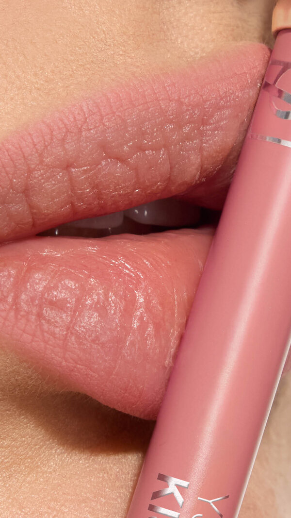 Adrienne's lips with YSL LOVENUDE Kiss Shaper 26 in Shade 44, a close-up showcasing the product.