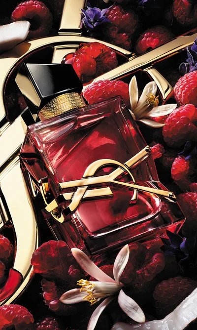 YSL Libre bottle with raspberries, creamy coconut, jasmine flowers, and lavender accents.