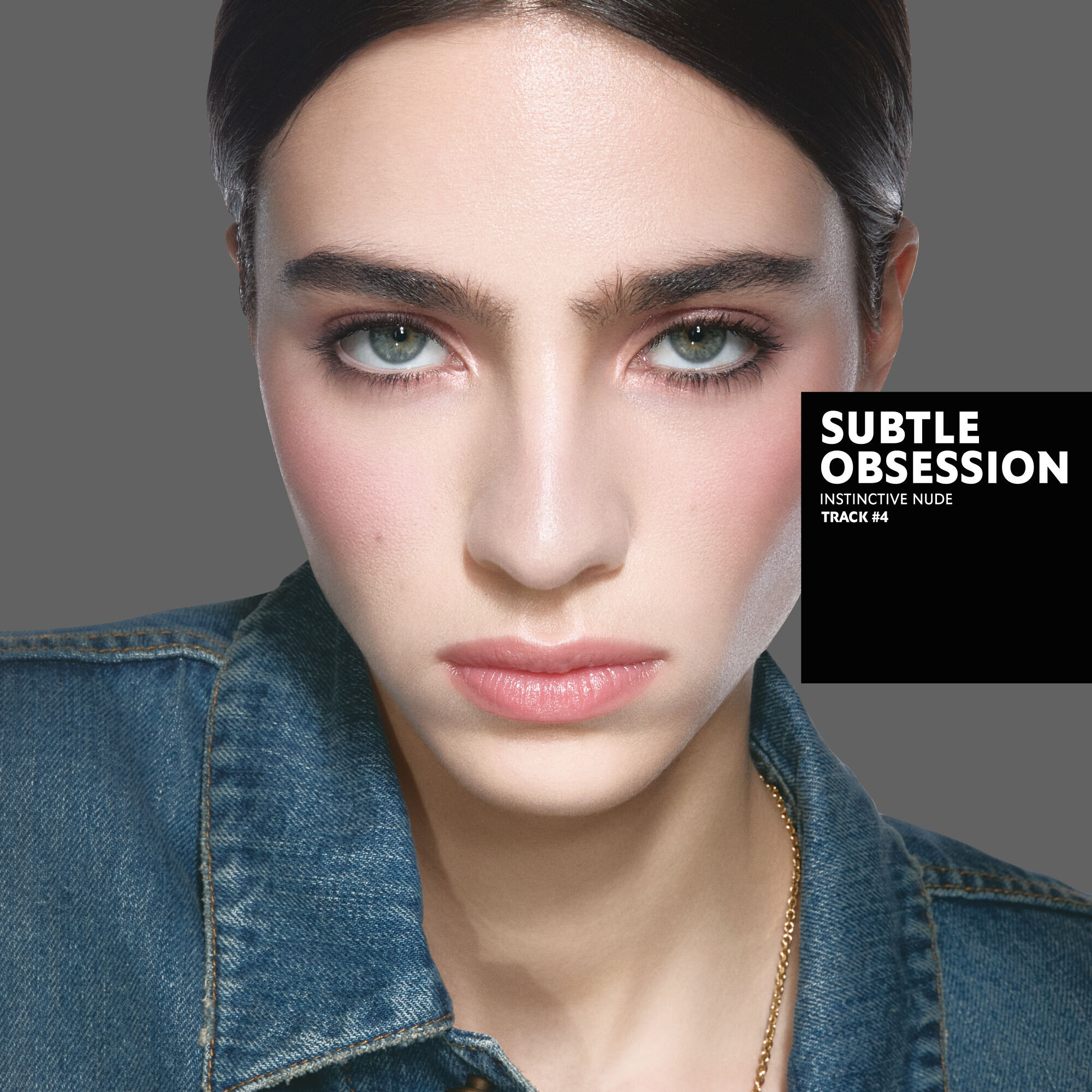 Loli, light skin tone, with an instinctive nude eye look and subtle obsession dunes glossy lips, wearing a denim jacket.