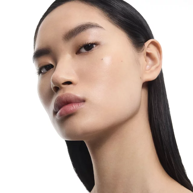 Mingma, YSL Beauty model, with radiant, natural skin. Close-up portrait.