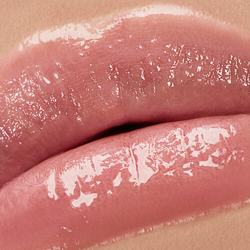 Close-up of lips wearing YSL LOVESHINE Lipstick in shade 44 Nude Lavaliere, showcasing a glossy, plump finish.