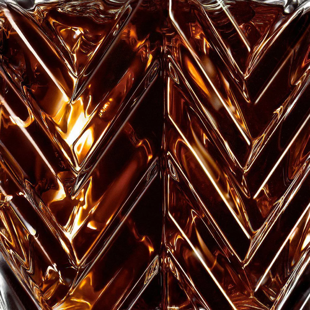 YSL LVDP Tuxedo Extrait de Parfum 50ml bottle, close-up on the elegant chevron glass pattern and amber liquid.