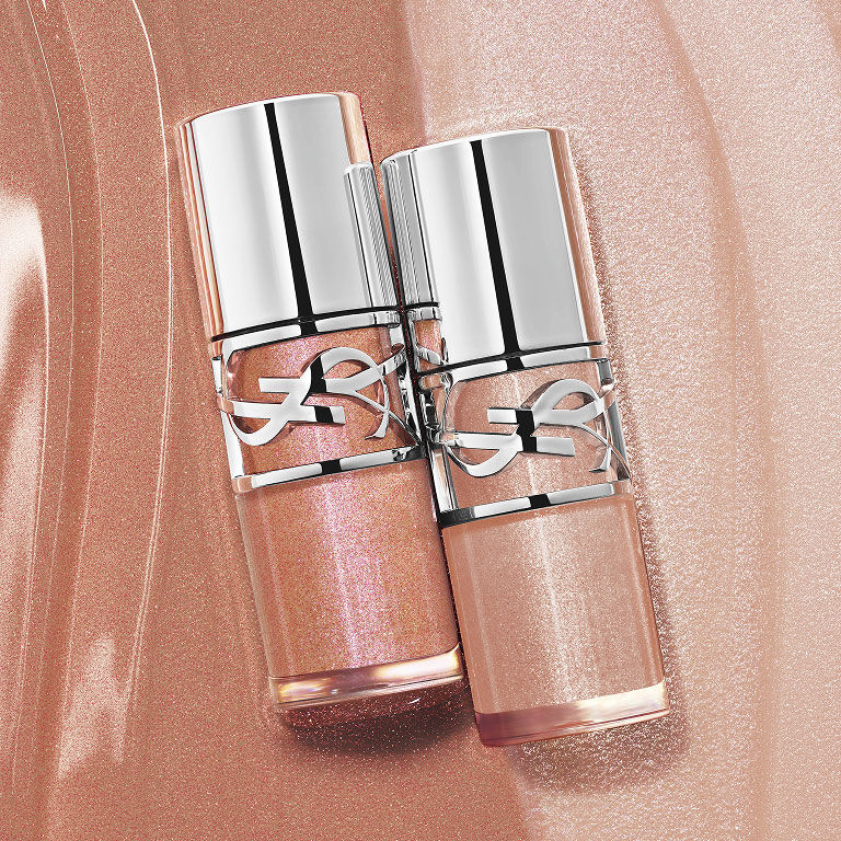 Two YSL LOVESHINE Plumping Lip Oil Glosses, shades 12 and 10, on a shimmering textured background.
