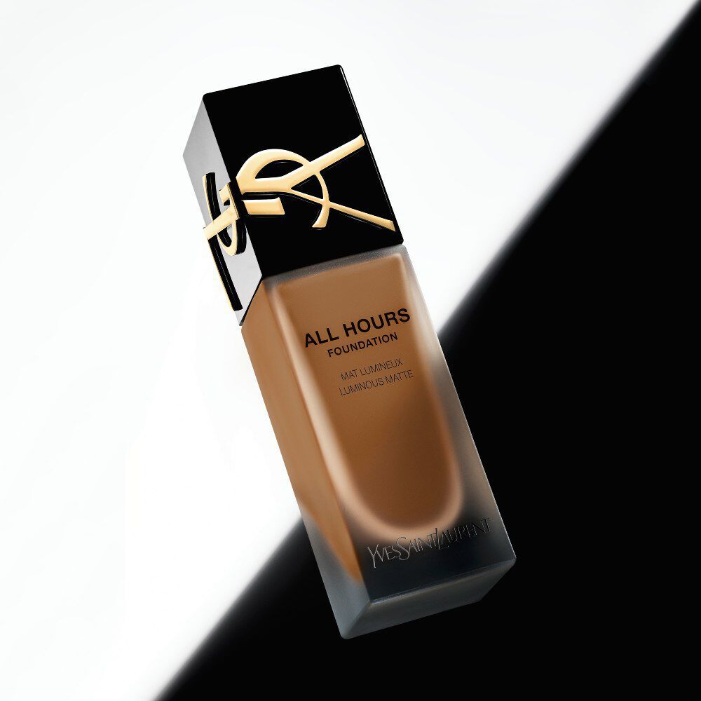 YSL All Hours Foundation bottle positioned diagonally against a sharp black-and-white split background.