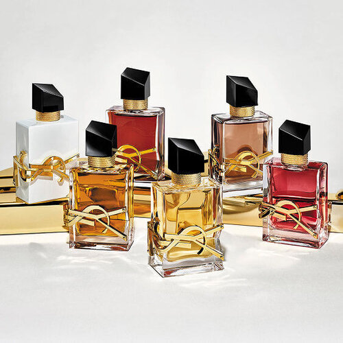 A luxurious display of the YSL Libre fragrance range, featuring multiple iconic bottles in various elegant shades.