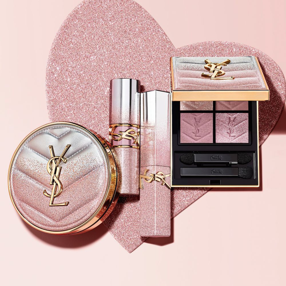 YSL Beauty Collector range featuring a cushion compact, lipsticks, and eyeshadow palette on a glittery heart background.