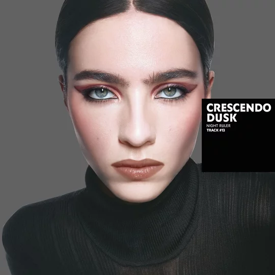 Loli, light skin tone, with a seductive couture bewitching black eye look and nude lips, wearing a black blazer.