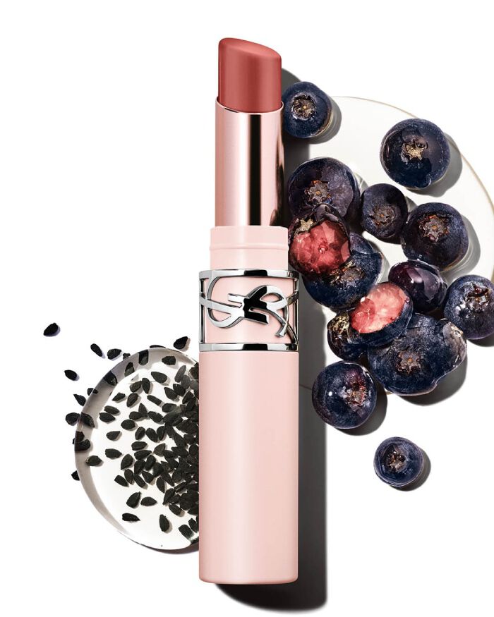 YSL LOVENUDE Lip Blusher in Shade 4, opened, with blueberries and black seeds, highlighting natural ingredients.