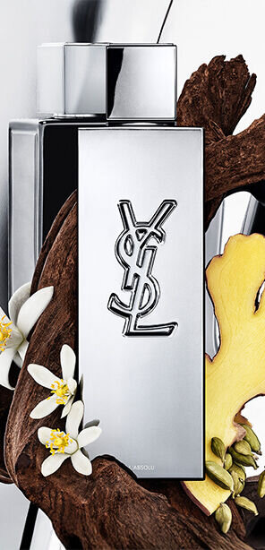 MYSLF L'Absolu fragrance bottle by YSL Beauty surrounded by ginger root, orange blossom and woods.