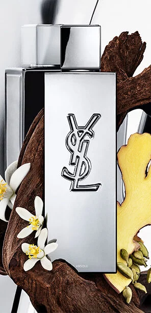 MYSLF L'Absolu fragrance bottle by YSL Beauty surrounded by ginger root, orange blossom and woods.