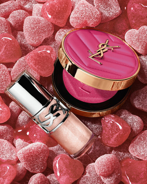 YSL LOVESHINE Plumping Lip Oil Gloss shade 10 and Make Me Blush shade 10, surrounded by pink heart-shaped sweets.