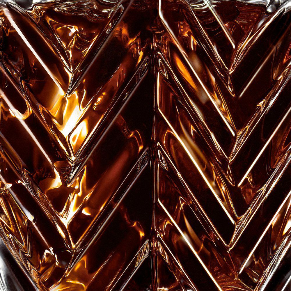 YSL LVDP Tuxedo Extrait de Parfum 50ml bottle, close-up on the elegant chevron glass pattern and amber liquid.