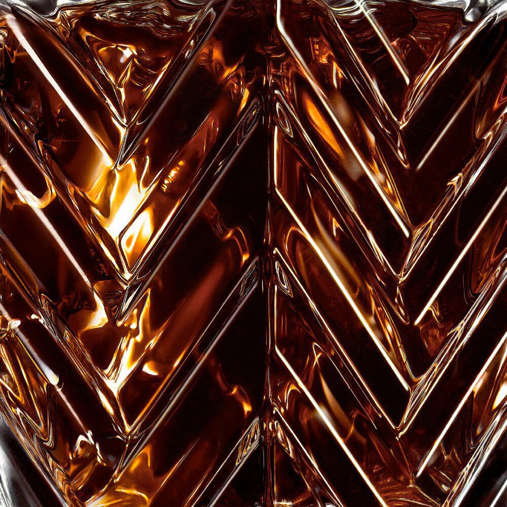 YSL LVDP Tuxedo Extrait de Parfum 50ml bottle, close-up on the elegant chevron glass pattern and amber liquid.