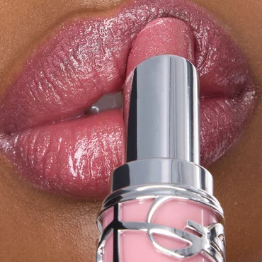 Najma applying YSL LOVESHINE Lipstick shade 215 to her shimmering lips, showcasing a radiant finish.