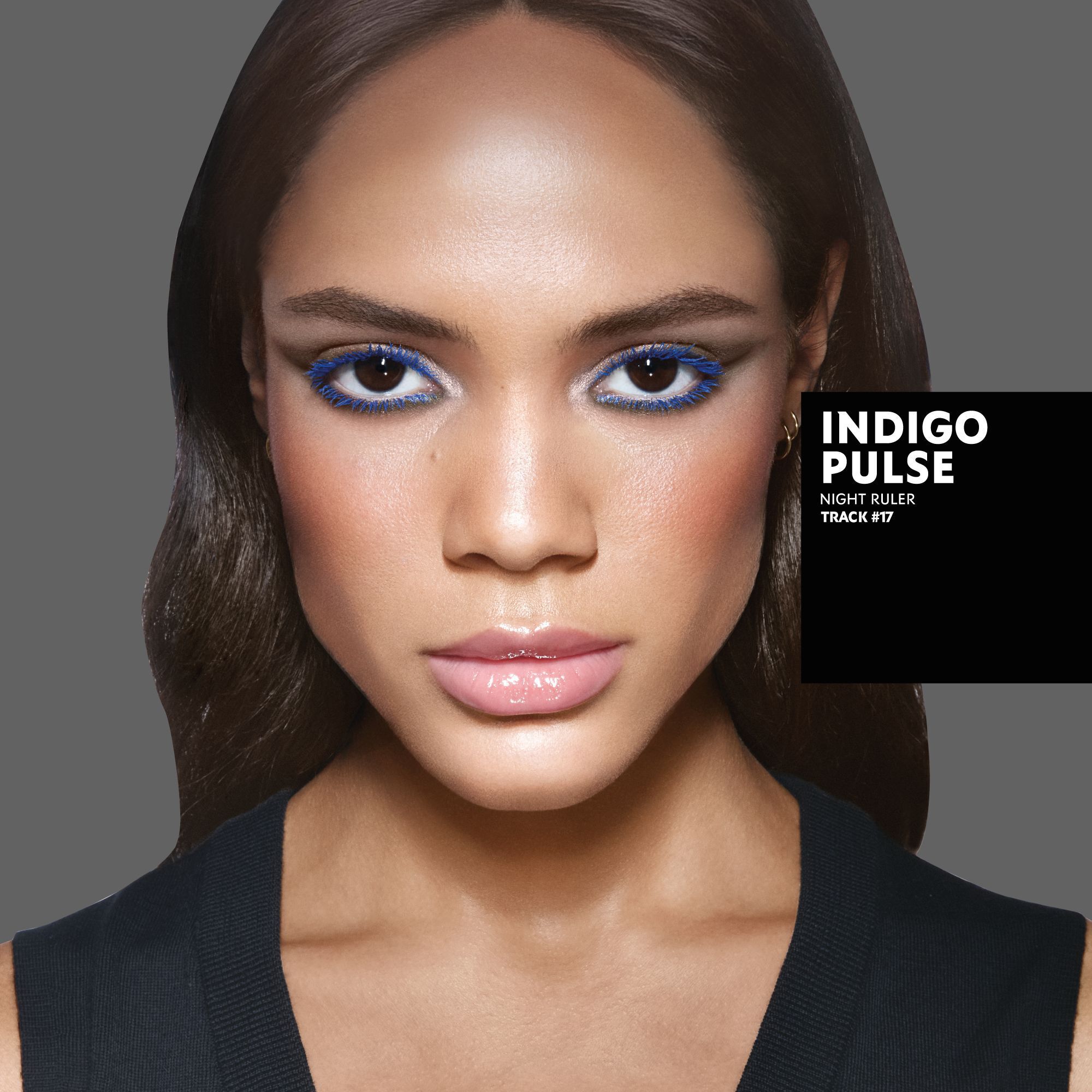 Kalixte, medium skin tone, with an indigo pulse eye look featuring bold blue eyeliner, and glossy nude lips.