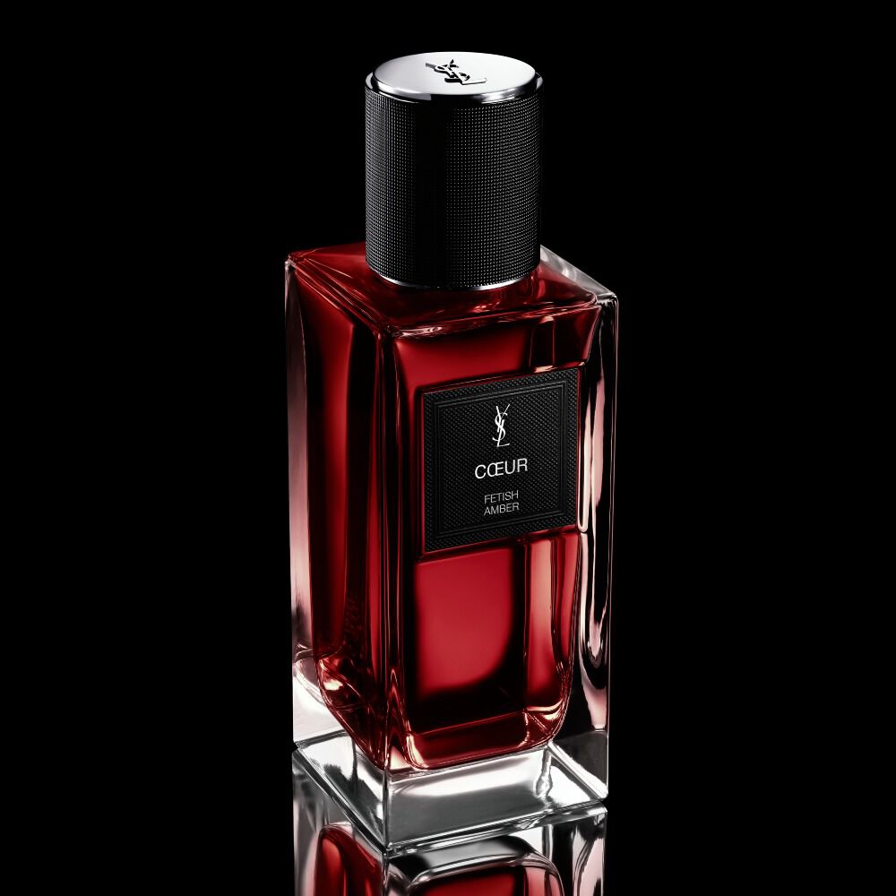 COEUR Eau de Parfum ruby-red bottle standing on a reflective black surface by YSL Beauty.