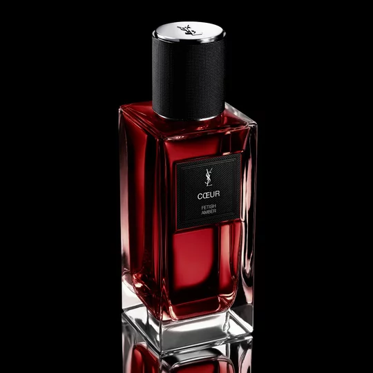 COEUR Eau de Parfum ruby-red bottle standing on a reflective black surface by YSL Beauty.