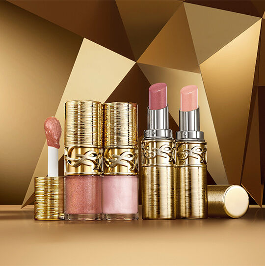 YSL Loveshine Plumping Lip Oil Gloss shade 12 and 100, and Loveshine Candy Glaze Collector in shades 22, and 21 on a gold background.