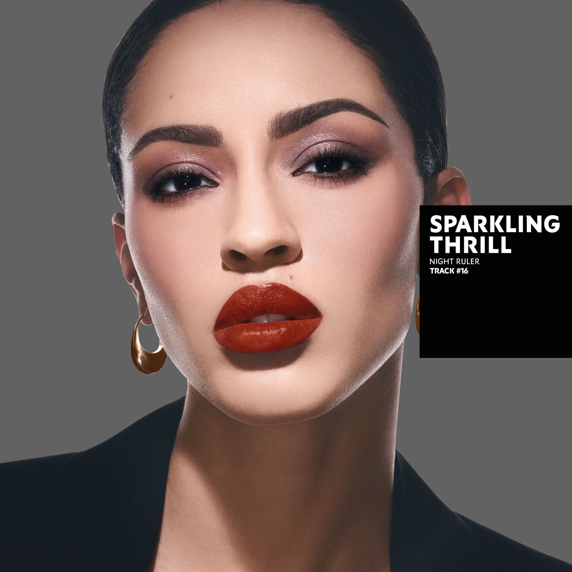 Karen, tanned skin tone, with a sparkling thrill eye look featuring pink and red, and bold red matte lips.