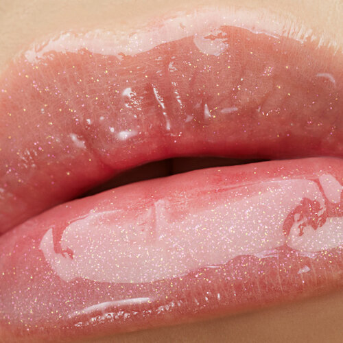 Close-up of lips wearing YSL LOVESHINE Plumping Gloss in shade 1, with a shimmering, high-shine finish.