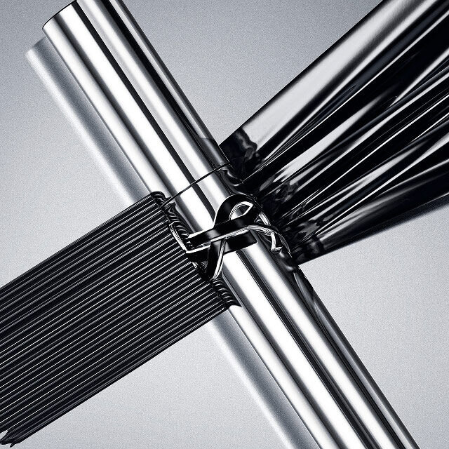 YSL Lash Latex Mascara in sleek silver packaging, showcasing rich black texture on a reflective grey background.