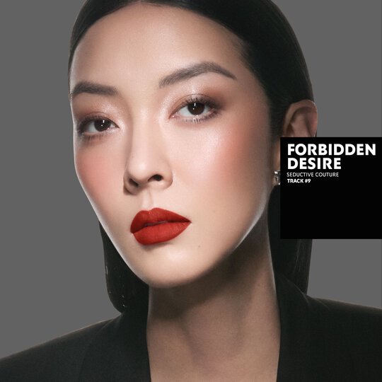 So-Young, fair skin tone, with a seductive couture eye look and forbidden desire red matte lips, wearing a black blazer.