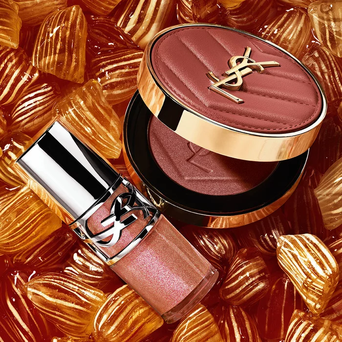YSL LOVESHINE Plumping Lip Oil Gloss shade 12 and Make Me Blush shade 12, nestled among golden berlingot sweets.