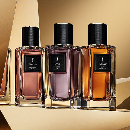 Le Vestiaire des Parfums trio: Blouse, Muse, and Tuxedo displayed on a reflective golden background.