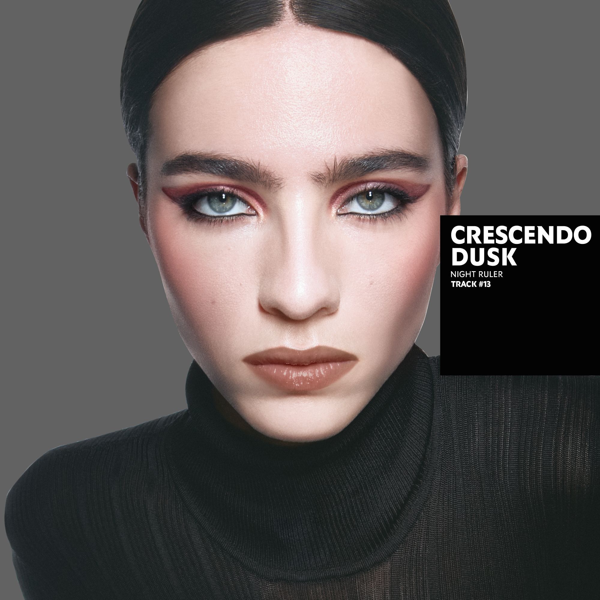 Loli, light skin tone, with a seductive couture bewitching black eye look and nude lips, wearing a black blazer.