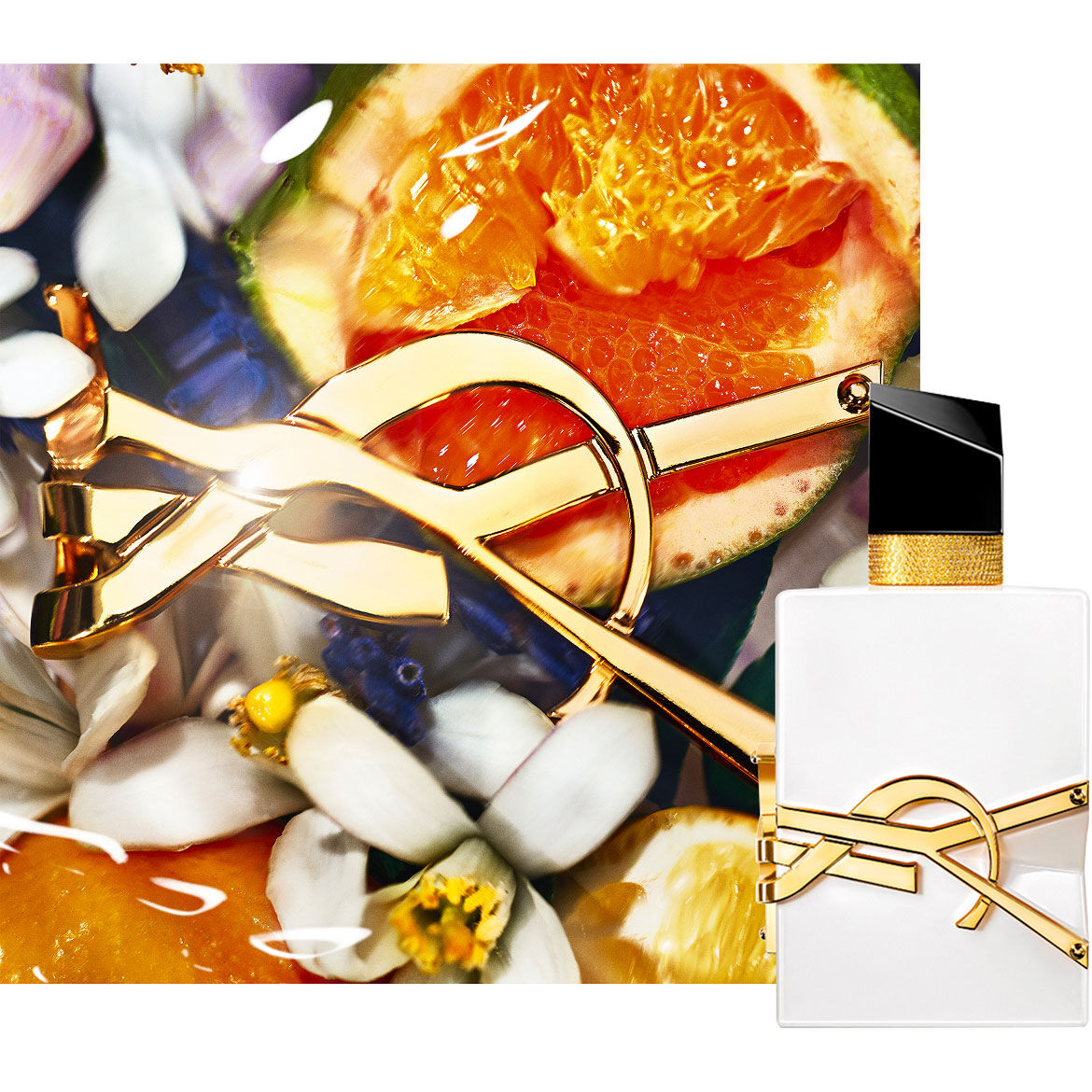 Libre L’EAU NUE alcohol-free bottle styled with white flowers and soft golden lighting.