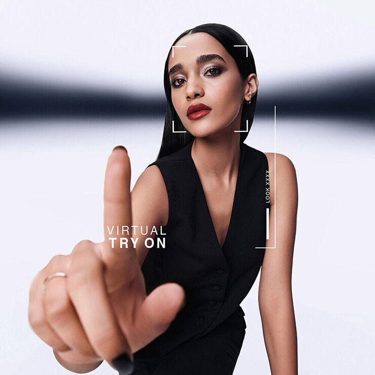 Model with sleek black hair and nails engaging with YSL's Virtual Try-On interface, modern and interactive.