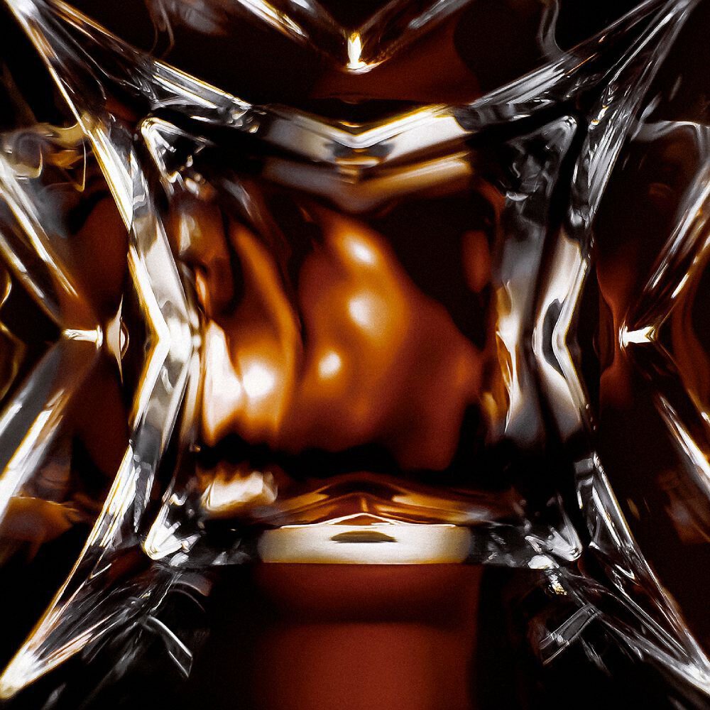 YSL LVDP Tuxedo Extrait de Parfum bottle, extreme close-up of the intricate glass design with luminous reflections.