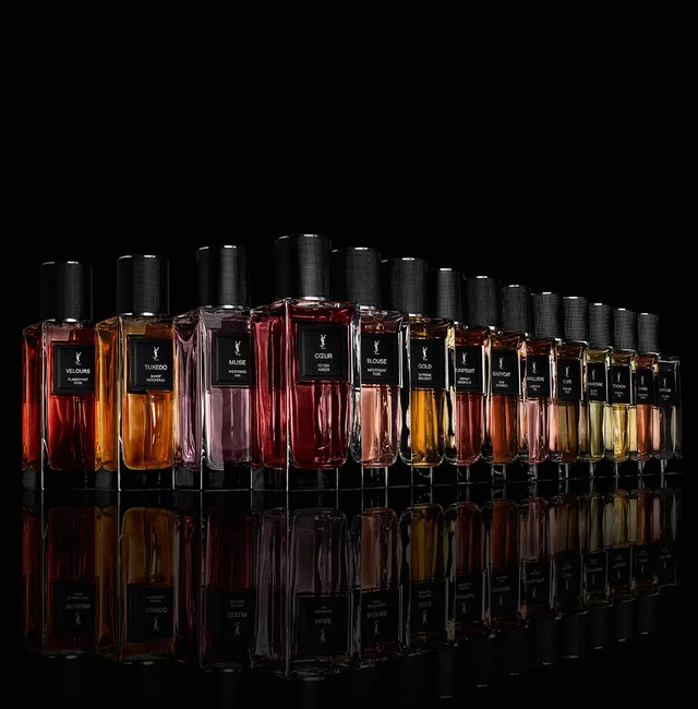 The complete Le Vestiaire des Parfums fragrance range standing on a reflective black mirror surface.
