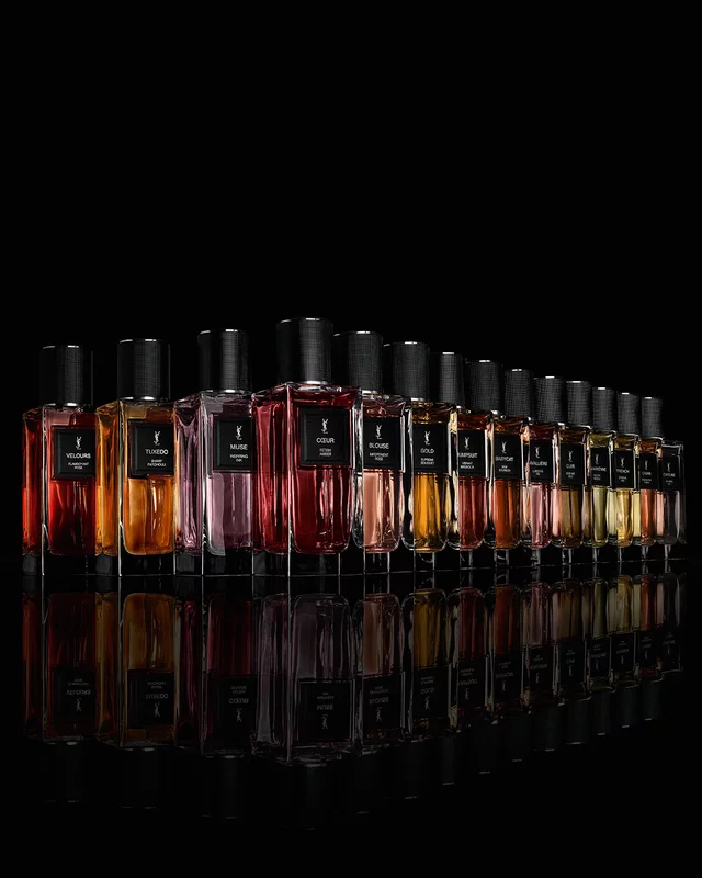 The complete Le Vestiaire des Parfums fragrance range standing on a reflective black mirror surface.