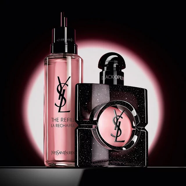 Black Opium Eau de Parfum bottle shown next to its 100ml glass refill bottle with the YSL logo.