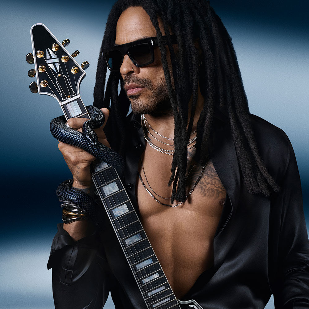 Lenny Kravitz, YSL Beauty ambassador, with a guitar and snake on a blue background.