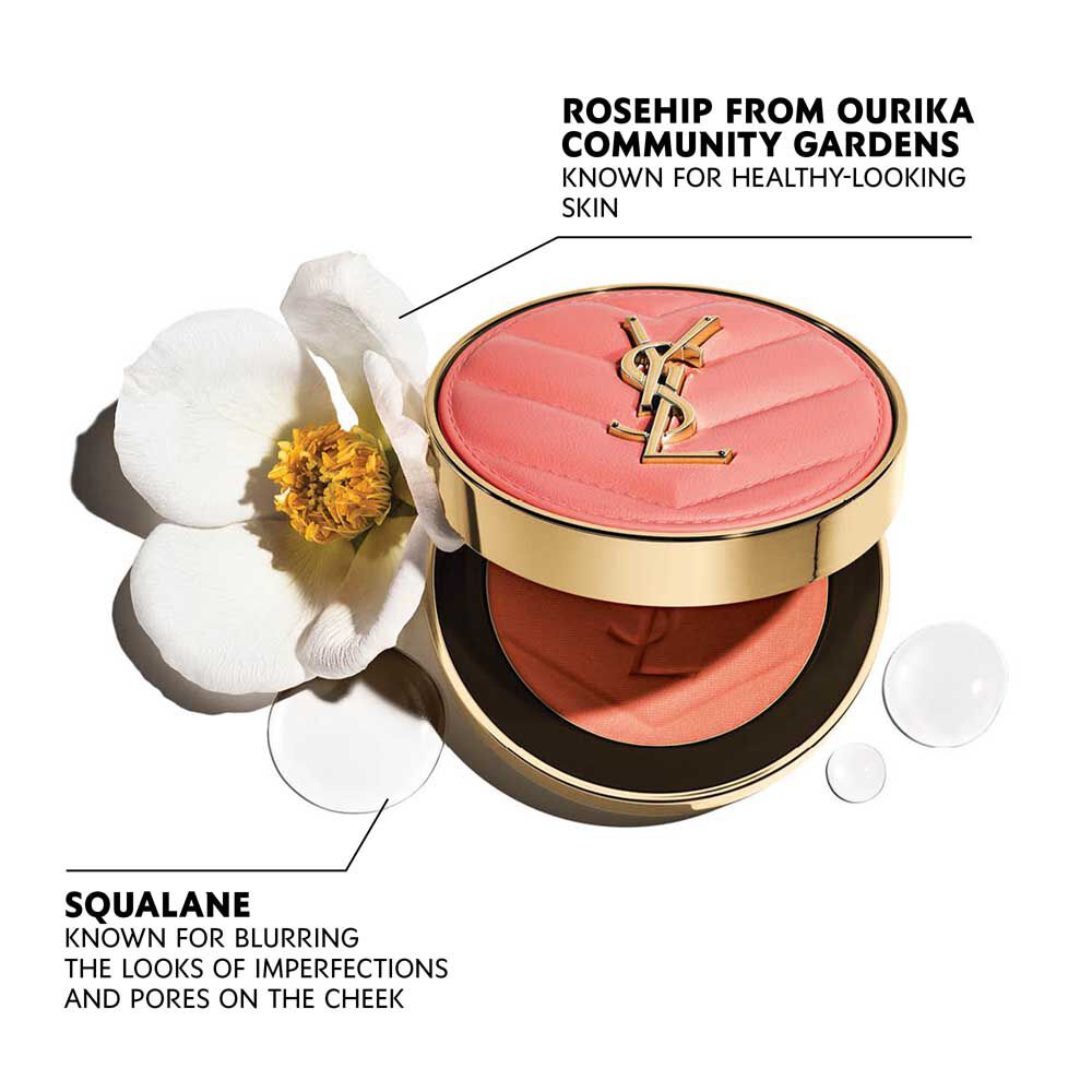 Open YSL Make Me Blush Powder Blush in shade 15, a vibrant red, with a delicate white flower and clear water droplets.
