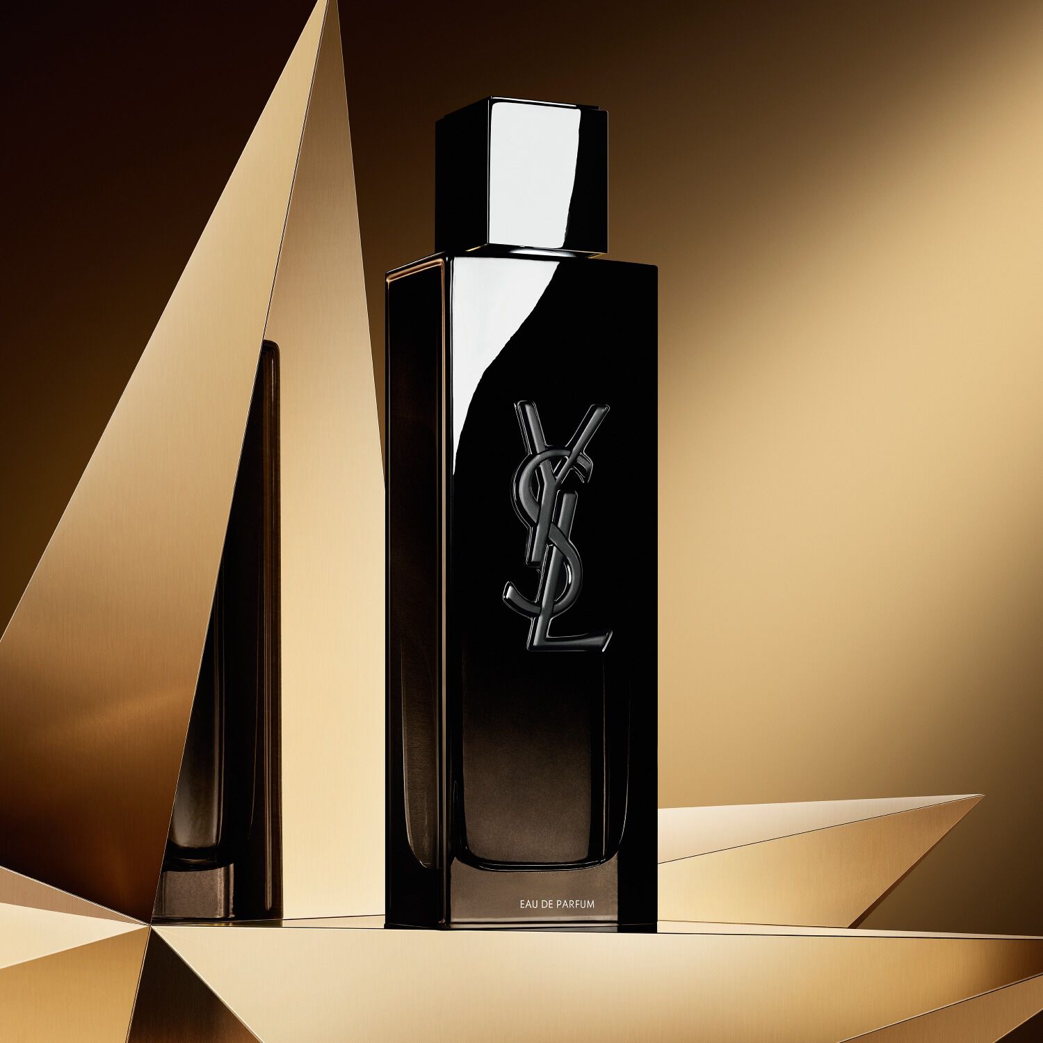MYSLF Eau de Parfum 100ml, a sleek black bottle with the YSL Beauty logo, on a golden geometric background.