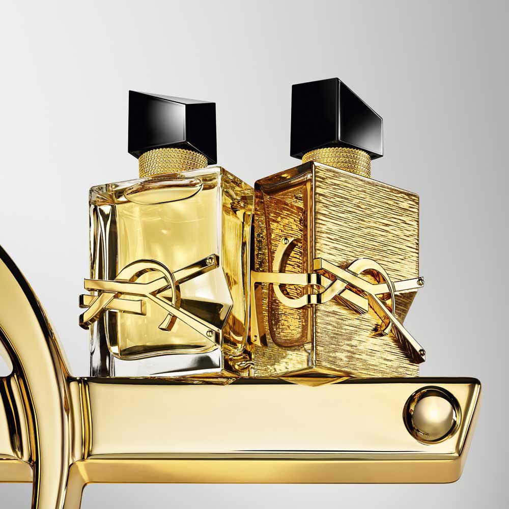 YSL Libre Fragrance duo: Eau de Parfum 50ml and Vanille Couture edition, gold-toned bottles on a luxurious gold base.