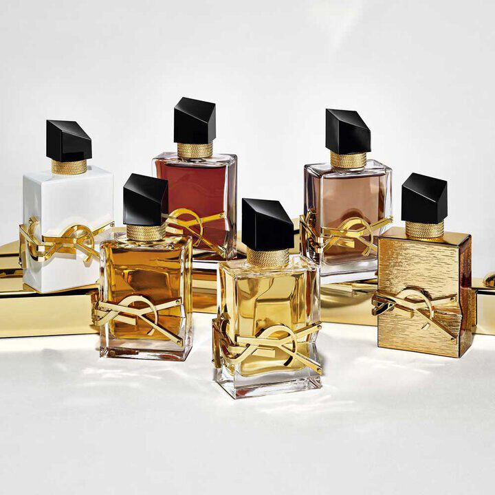 YSL Libre fragrance collection: six bottles in various shades, featuring gold accents, embedded YSL Beauty logo and black caps.