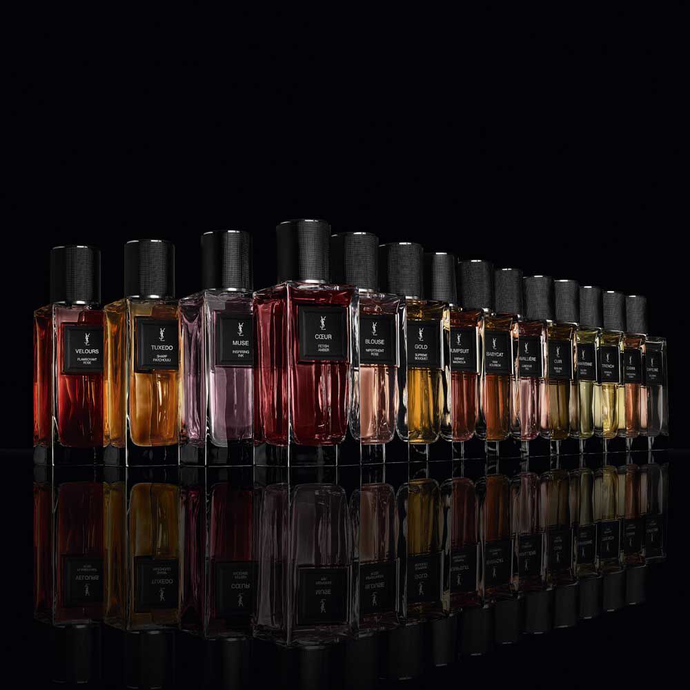 The complete Le Vestiaire des Parfums fragrance range standing on a reflective black mirror surface.