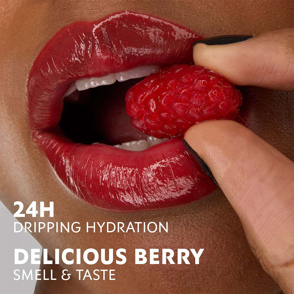 Model Zahara with YSL Loveshine Lipstick in Berry Crush, holding a raspberry, highlighting hydration and berry scent.